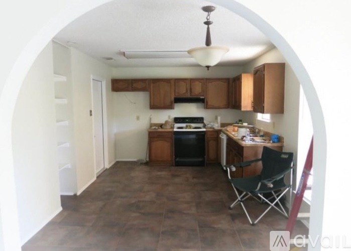 A kitchen with a table and chairs in the middle of the room.