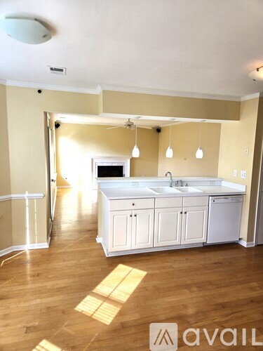 A kitchen with wooden floors and white appliances.