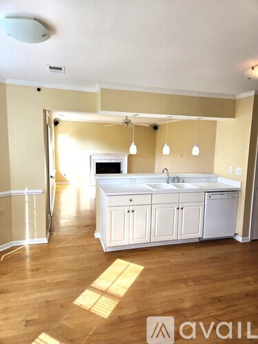 A kitchen with wooden floors and white appliances.