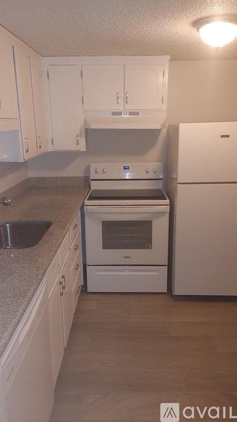 A kitchen with a stove, oven, and sink.