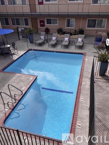 A small pool with a metal fence around it.