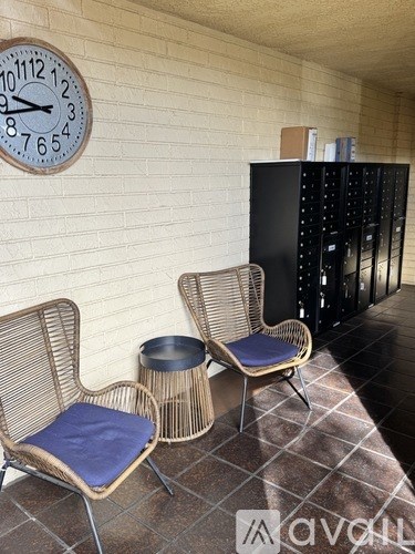 Two chairs with a clock on the wall behind them.