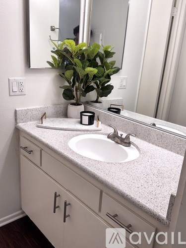 A bathroom with a sink and a mirror.