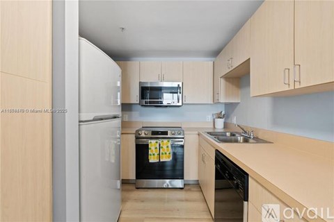 A kitchen with wooden cabinets and a white refrigerator.