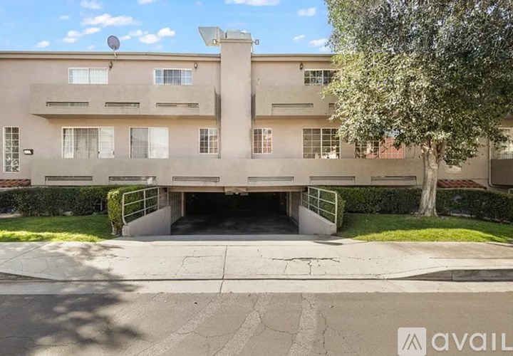 A building with a tree in front of it.
