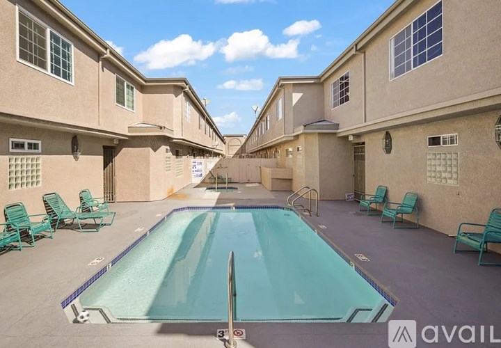 A swimming pool in the middle of a courtyard surrounded by buildings.