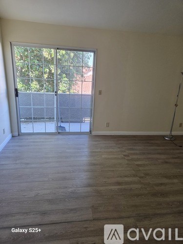 A room with a Galaxy S25+ smartphone on the floor.