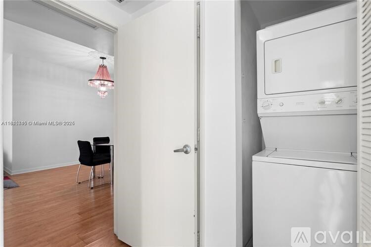 A white oven is in a kitchen next to a black chair.