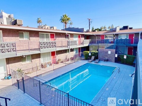 A pool surrounded by apartment buildings.