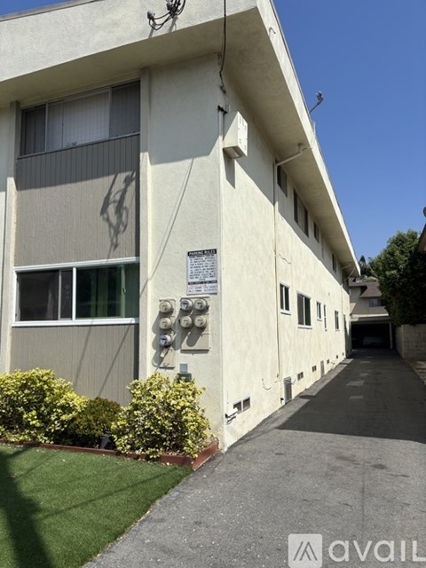 A kitchen with a stainless steel refrigerator and white cabinets.
