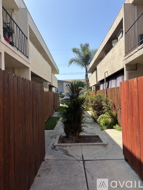A room with a ceiling fan and a mirror on the wall.