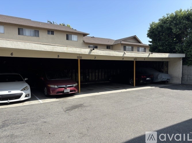 A small bathroom with a toilet, a window, and a towel rack.
