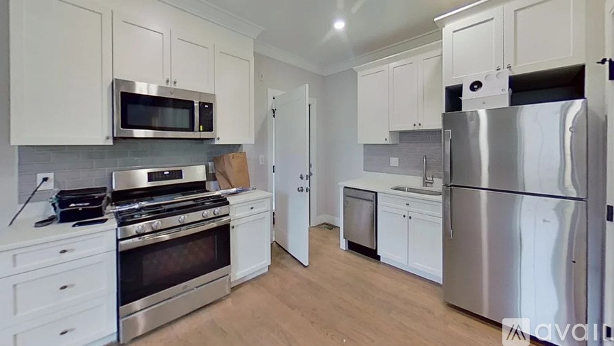 A kitchen with white cabinets and stainless steel appliances.