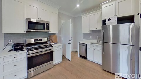 A kitchen with white cabinets and stainless steel appliances.