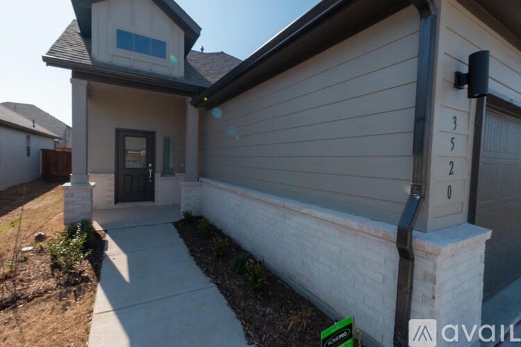 A house with a black door and a window is shown.