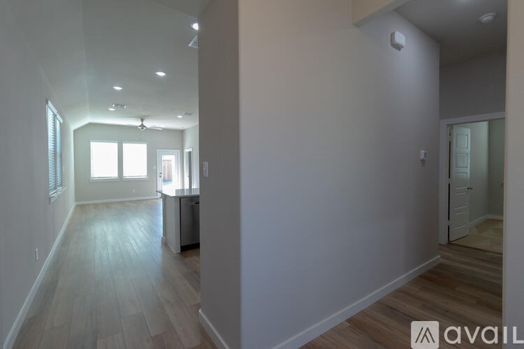 A room with a wooden floor and white walls.
