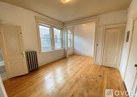 A room with wooden floors and white walls.