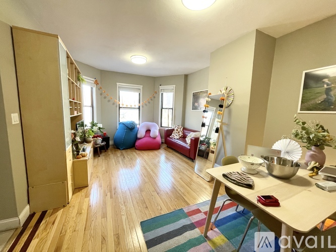 A living room with a wooden floor and a white ceiling.