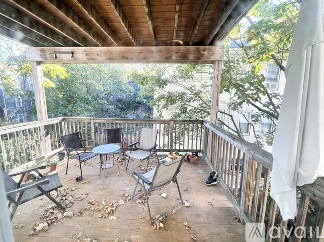 A wooden deck with a table and chairs.
