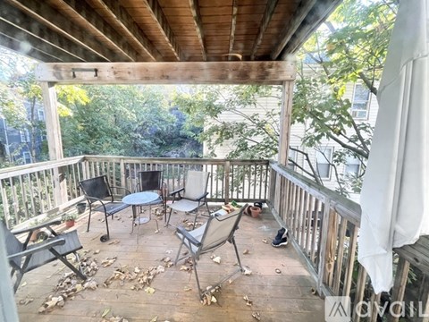 A wooden deck with a table and chairs.
