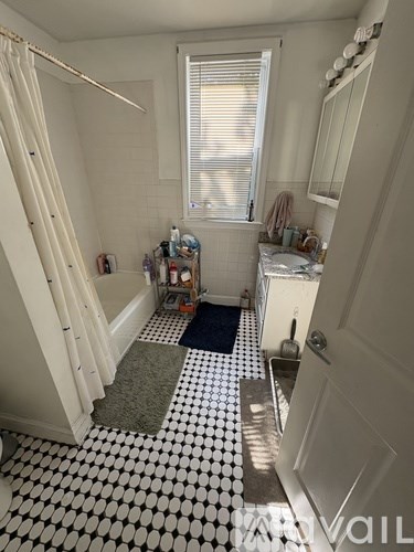 A bathroom with a black and white checkered floor.