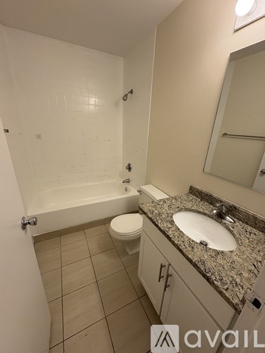 A bathroom with a sink, toilet and bathtub.