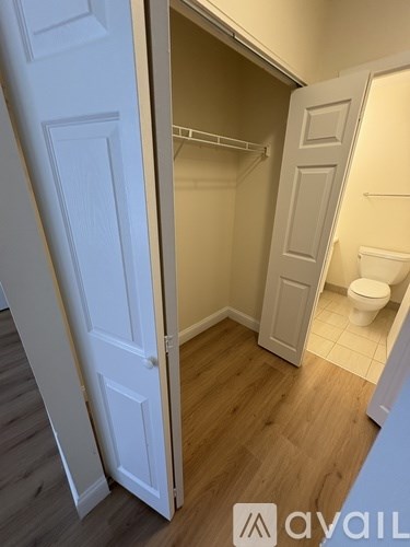 A small bathroom with a toilet and a walk-in closet.