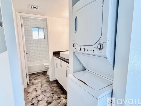A white washing machine in a laundry room.