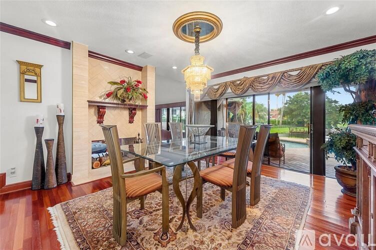 A dining room with a glass table and chairs.