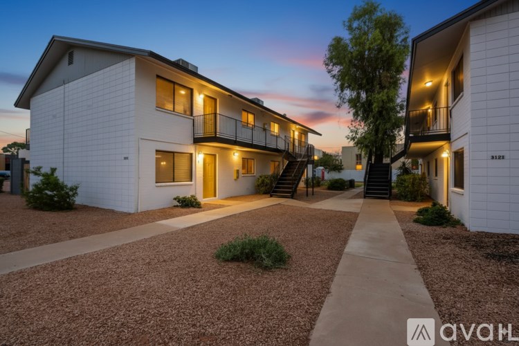 A modern apartment complex with a pathway leading to the entrance.