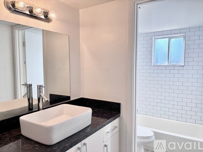 A bathroom with a white sink and a mirror above it.