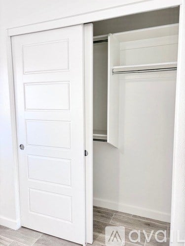 A white door with a shelf inside it.
