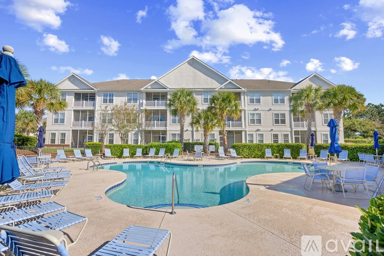 A large building with a pool in front of it.