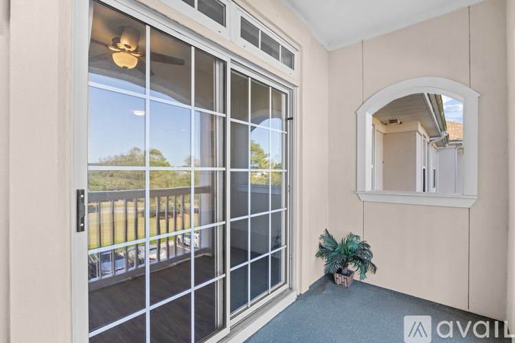 A room with a sliding glass door leading to a balcony.