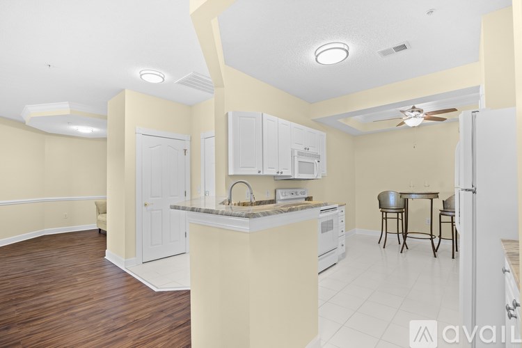 A kitchen with a table and chairs in the middle of the room.