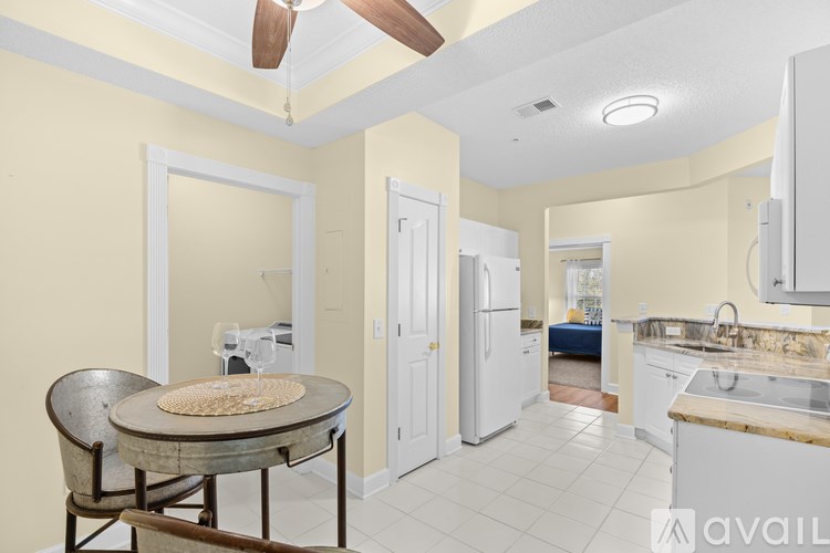 A kitchen with a table and chairs in the middle of the room.