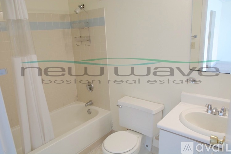 A white toilet and sink in a bathroom.