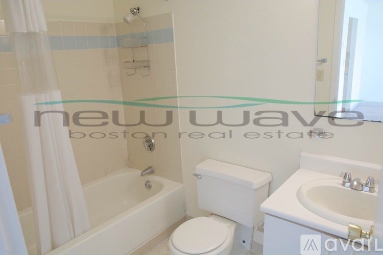 A white toilet and sink in a bathroom.