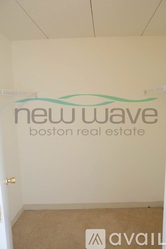 A room with a sign that says New Wave Boston Real Estate.