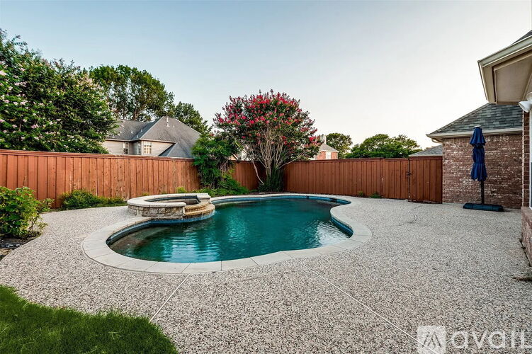 A small round pool surrounded by a gravel area.