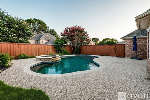 A small round pool surrounded by a gravel area.