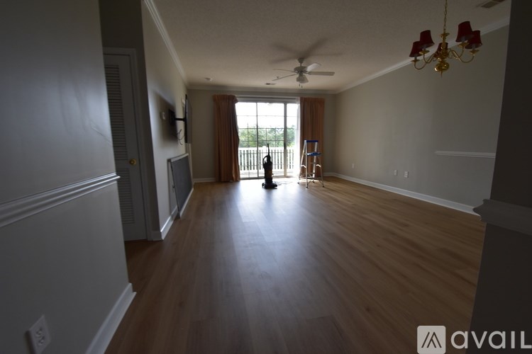 A room with wooden floors and a ceiling fan.