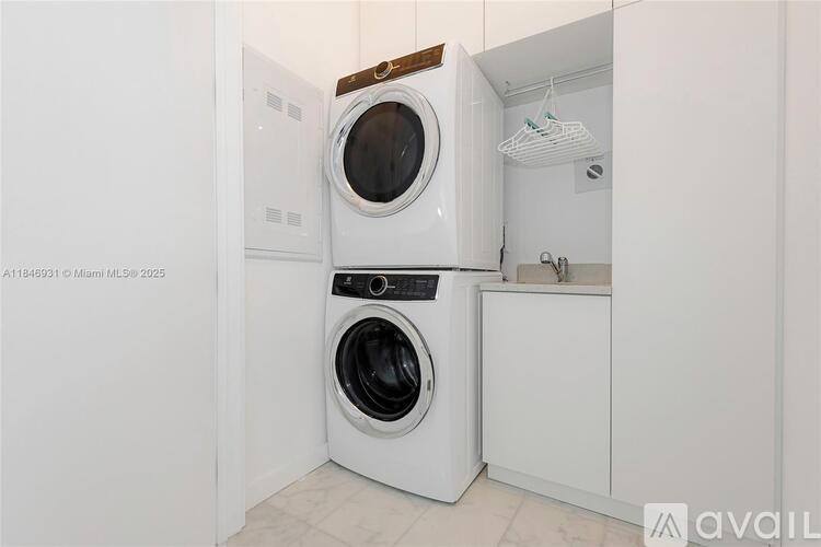 A white washing machine and dryer in a small laundry room.