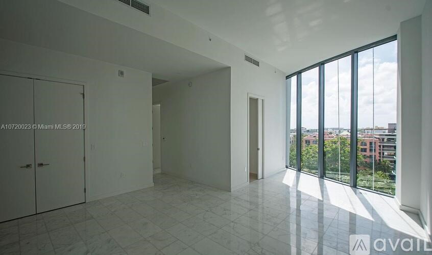 A large empty room with a view of the city.