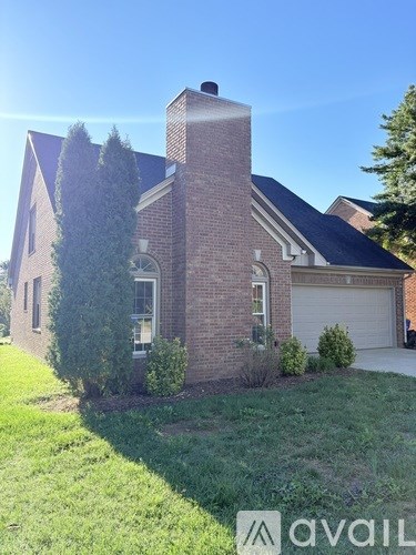 A house with a chimney and a garage door.