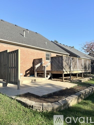 A house with a brick facade and a black gate.