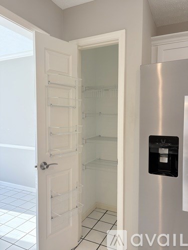 A white door with a glass panel and a handle is open.