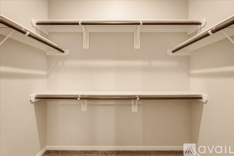 Empty shelves in a white pantry.
