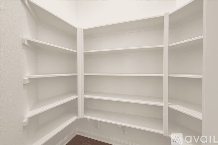 Empty white shelves in a room.