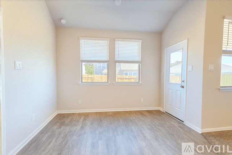 A room with a white door and a window with blinds.